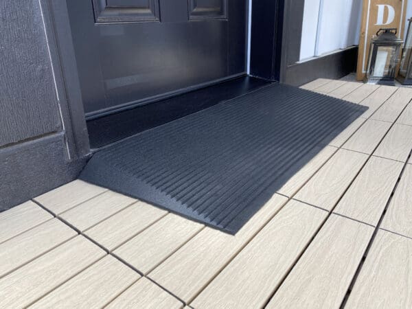 A door mat that is on the ground.