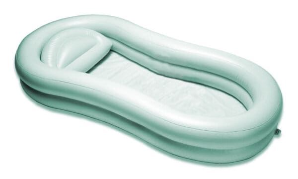 A white inflatable pool with a pillow on top of it.