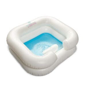 A white inflatable pool with blue water inside of it.