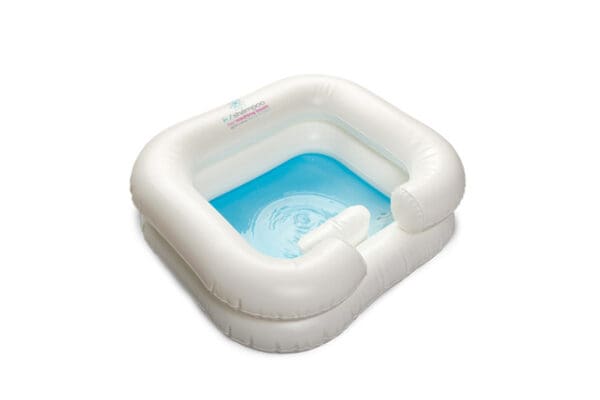 A white inflatable pool with blue water inside of it.