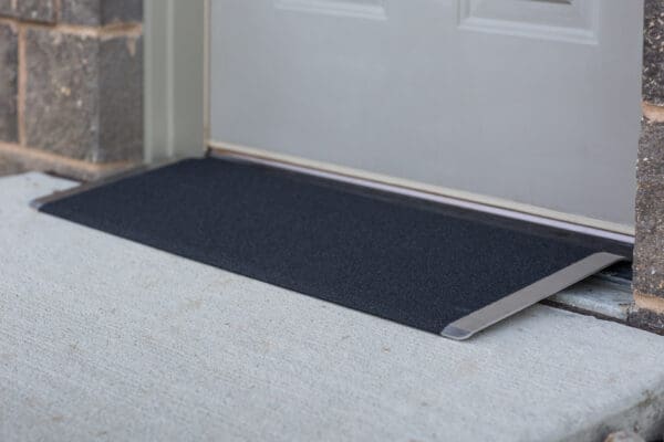 A ramp is attached to the front of a door.