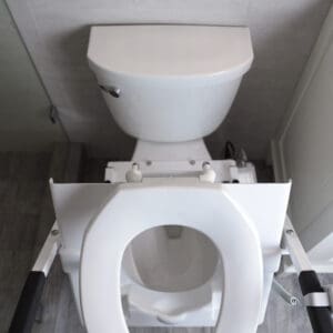 A toilet with the seat up in a bathroom.