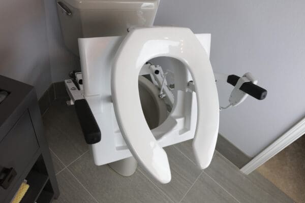 A toilet seat with the lid up in a bathroom.