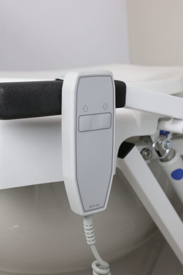 A white and black control panel in front of a sink.