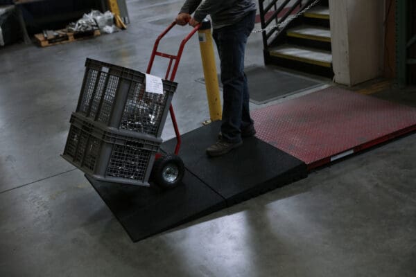 A person pushing a cart down the stairs