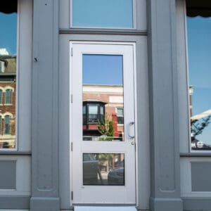 A white door with two windows on the outside of a building.