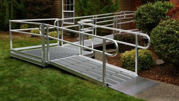 A metal ramp with handrails going up to the side of it.